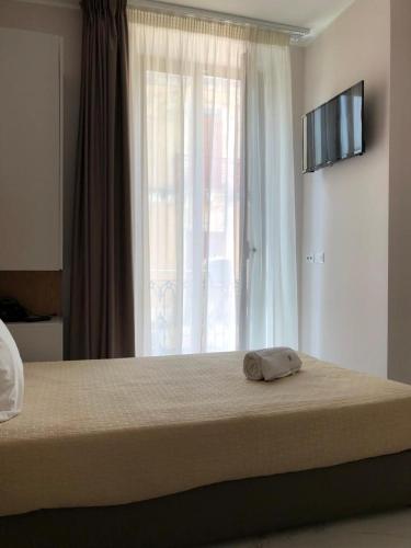 Ένα ή περισσότερα κρεβάτια σε δωμάτιο στο Albergo Milazzo Inn AiMori
