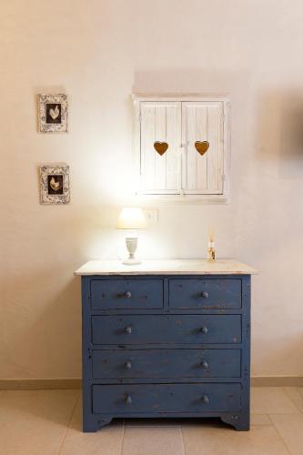 a blue dresser with a lamp on top of it at Palazzo Badiale history&rooms in Atella