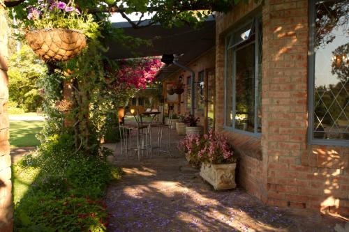 a building with flowers on the side of it at Gerald's Gift Guest House in Addo