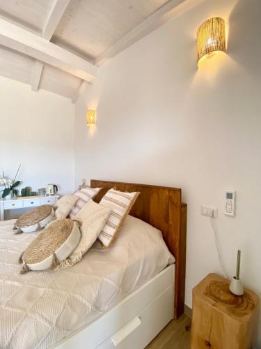 a bedroom with a bed with pillows on it at B&B Anastasia in Santa Teresa Gallura