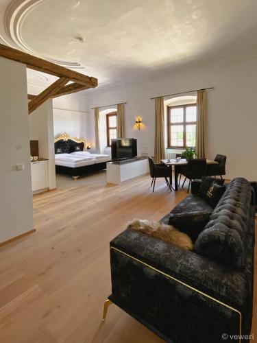 a living room with a couch and a table at Innviertler Versailles in Aurolzmünster
