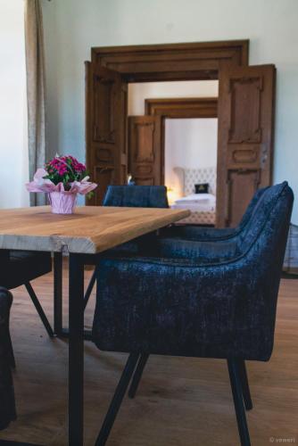 a dining room table with a vase of flowers on it at Innviertler Versailles in Aurolzmünster