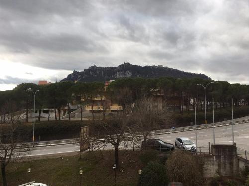 a view of a mountain with cars on a highway at Hotel Rossi in San Marino