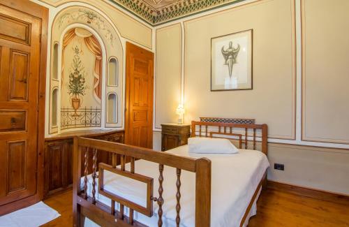 a bedroom with a bed and a wooden staircase at Old Legends Hotel in Plovdiv