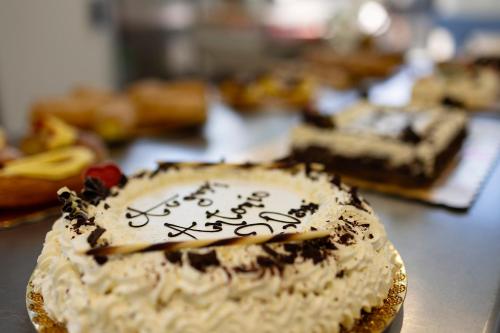 a cake with writing on it sitting on a table at Palazzo Badiale history&rooms in Atella