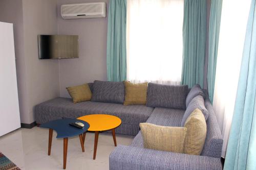 a living room with a couch and a table at Alpat Homes in Kemer