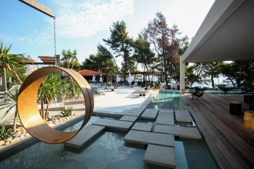 a swimming pool with a swing and a swimming pool at Nostos Hotel in Afitos