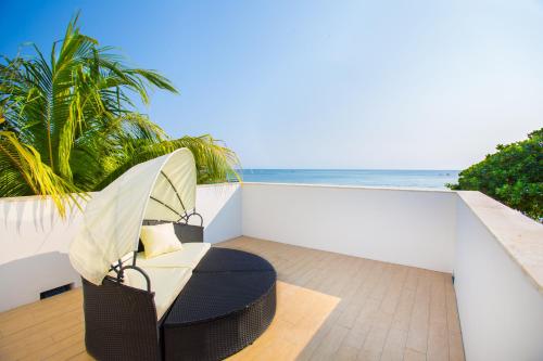 a chair on a balcony with the ocean in the background at Bella Luna Beach Condo #227473 in West End