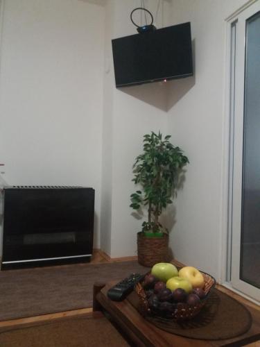 a bowl of fruit on a table in a living room at Apartman Breza in Ruma