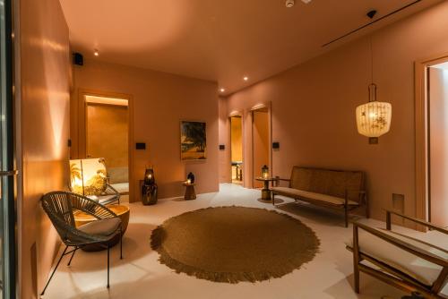 a living room with a couch and a rug at Koukoumi Vegan Boutique Hotel in Ano Mera