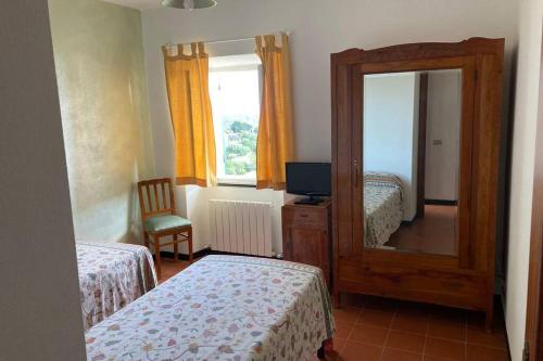 a bedroom with two beds and a mirror at LA FINESTRA SUL GOLFO - CITRA 010018-LT-0033 - in Cogorno