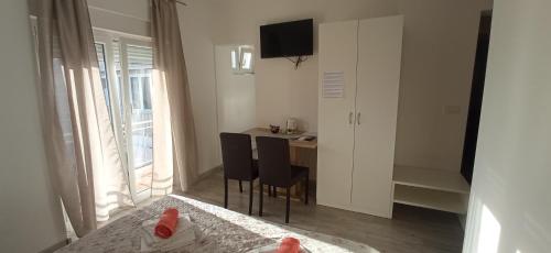 een slaapkamer met een bed en een tafel en stoelen bij E&A in Baška Voda