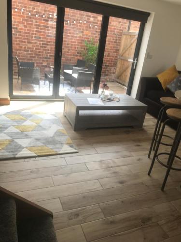 a living room with a couch and a coffee table at No 6 Elizabeth Street in Congleton