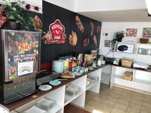 a kitchen with a counter with food on it at Hőforrás Hotel in Gyula