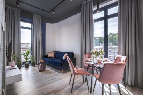 a living room with a blue couch and a table at Luxo apartments 14 in Jelenia Góra