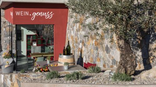 a store with a bottle of wine in front of a building at Hotel Weingut Innerleiterhof in Schenna