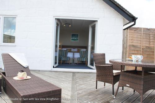 a patio with a table and chairs and a dining room at The Old Quay House in Hayle