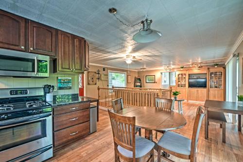 a kitchen with a wooden table and a dining room at Lake Barkley Home Private Dock, Kayaks, Fire Pit! in Cadiz