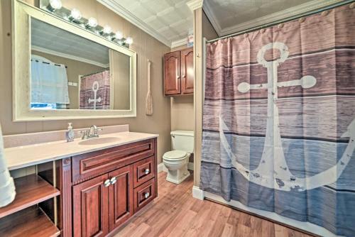 a bathroom with a shower and a sink and a toilet at Lake Barkley Home Private Dock, Kayaks, Fire Pit! in Cadiz