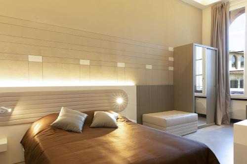a bedroom with a large bed and a window at Palazzo dei Ciompi Suites in Florence