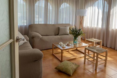a living room with a couch and a coffee table at Can Cristus in Monells