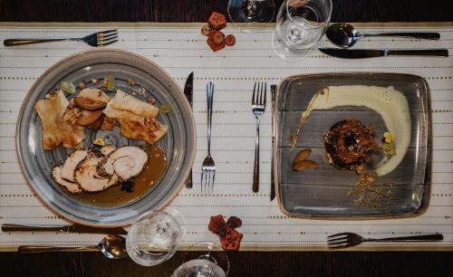 a table with two plates of food on it at Korona Pension and Restaurant in Hévíz