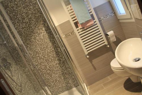 a bathroom with a shower with a toilet and a sink at Hotel Bologna in Genova