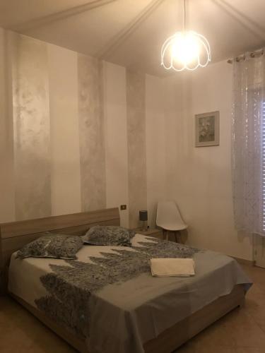 a bedroom with a large bed with a light at Casa Talita in Caprino Veronese