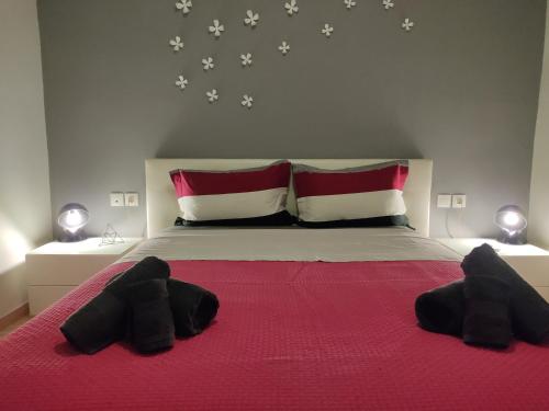 a bedroom with a large bed with red and white pillows at Estrela Comfortable Home in Volos