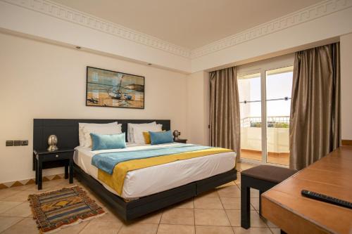a bedroom with a king sized bed and a desk at Ocean Atlantic View (Ex Bo Hotel) in Agadir