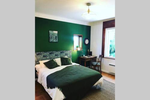 1 dormitorio con paredes verdes, 1 cama y escritorio en Villa de charme parc fleuri, arboré et piscine à BIARRITZ en Biarritz