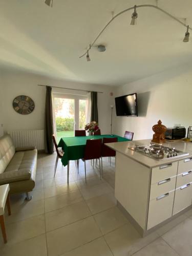 a kitchen and living room with a table and a couch at Antistress Affittacamere in Osimo