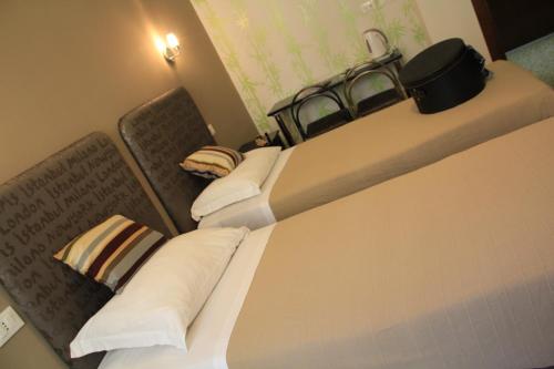 a hotel room with two beds and a counter top at Hotel Bologna in Genova
