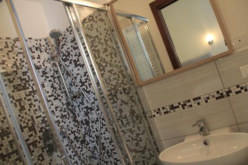 a bathroom with a shower and a sink at Hotel Bologna in Genova