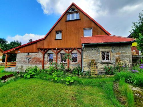 a large barn with a red roof at SCOTS Pokoje Gościnne in Szklarska Poręba