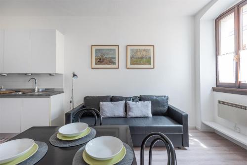 a living room with a couch and a table at Casa Anna in Riva del Garda