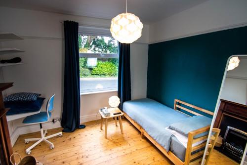 a bedroom with a bed and a window at Peaceful House in the Centre of City in Lancaster