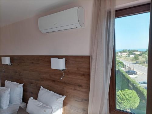 a hotel room with a bed and a large window at Hotel Vanilla, Varna - Free parking in Varna City
