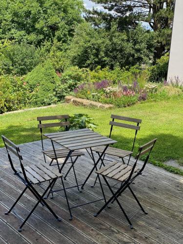 a picnic table and chairs on a wooden deck at Vikendovka Korce in Dubá