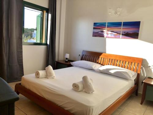 a bedroom with a bed with two towels on it at La Mundial Formentera in Es Pujols