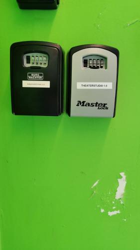 two electronic devices sitting on top of a green table at Theaterstudio 1 Antwerp in Antwerp
