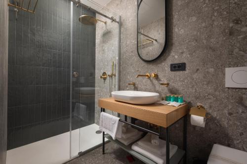 a bathroom with a sink and a shower at Heritage Hotel Porin Makarska in Makarska