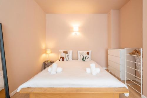 a bedroom with a large white bed with two pillows at Theaterstudio 1 Antwerp in Antwerp