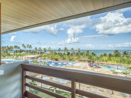 a view of the beach from the balcony of a resort at Japaratinga Lounge Resort - All Inclusive in Japaratinga