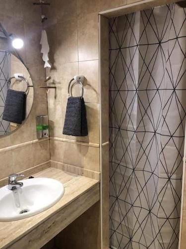 a bathroom with a sink and a shower at La Mundial Formentera in Es Pujols