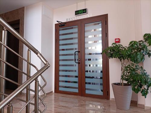 a revolving door in a building with a plant at Hotel Vanilla, Varna - Free parking in Varna City