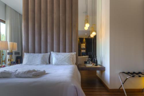 a bedroom with a large bed and a large window at Hotel Rural Vale Do Rio in Oliveira de Azemeis