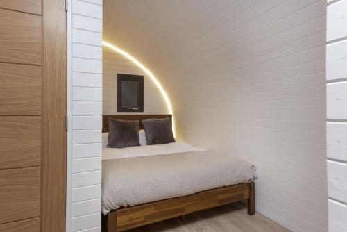 a bedroom with a bed in a room with a wall at Harbour Hideaway in Newlyn