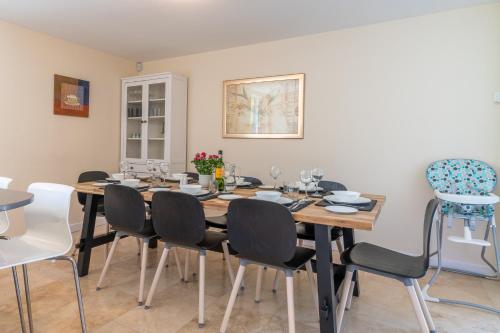 a dining room with a wooden table and chairs at Hill View Rise in Chipping Campden