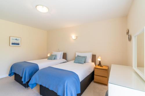 two beds sitting next to each other in a room at Hill View Rise in Chipping Campden